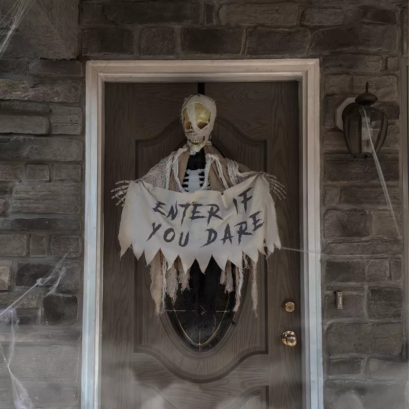 Animatronic Skeleton Mummy Greeter with Banner and Folding Door Hook for Scary Halloween Decoration